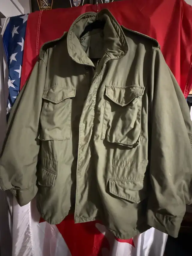 Photo of Original Vintage issue late 1960s 1970s M65 olive green fall winter combat jacket Vietnam era.