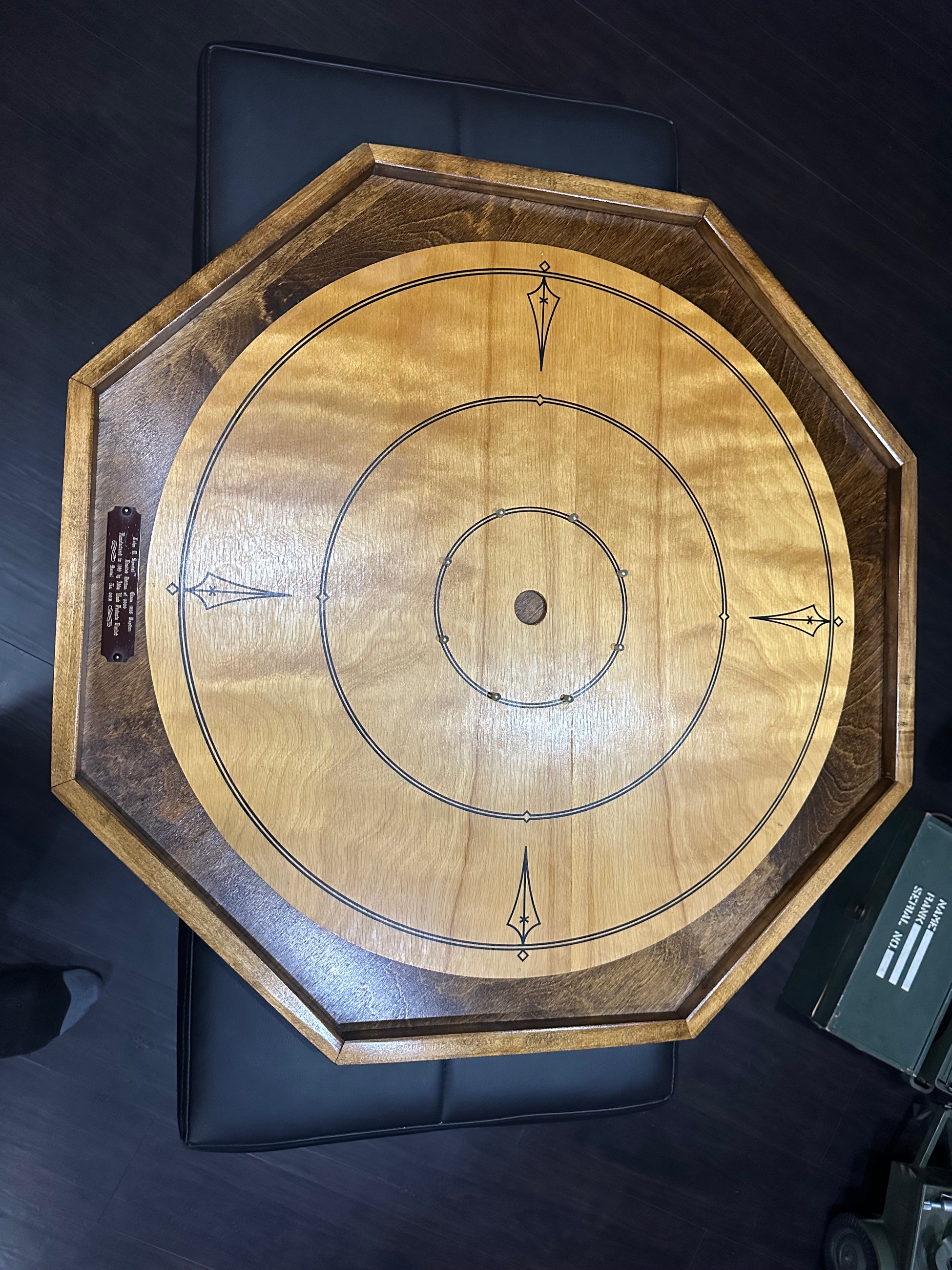 Photo of John B Diefenbaker Carokinole board and piece with book