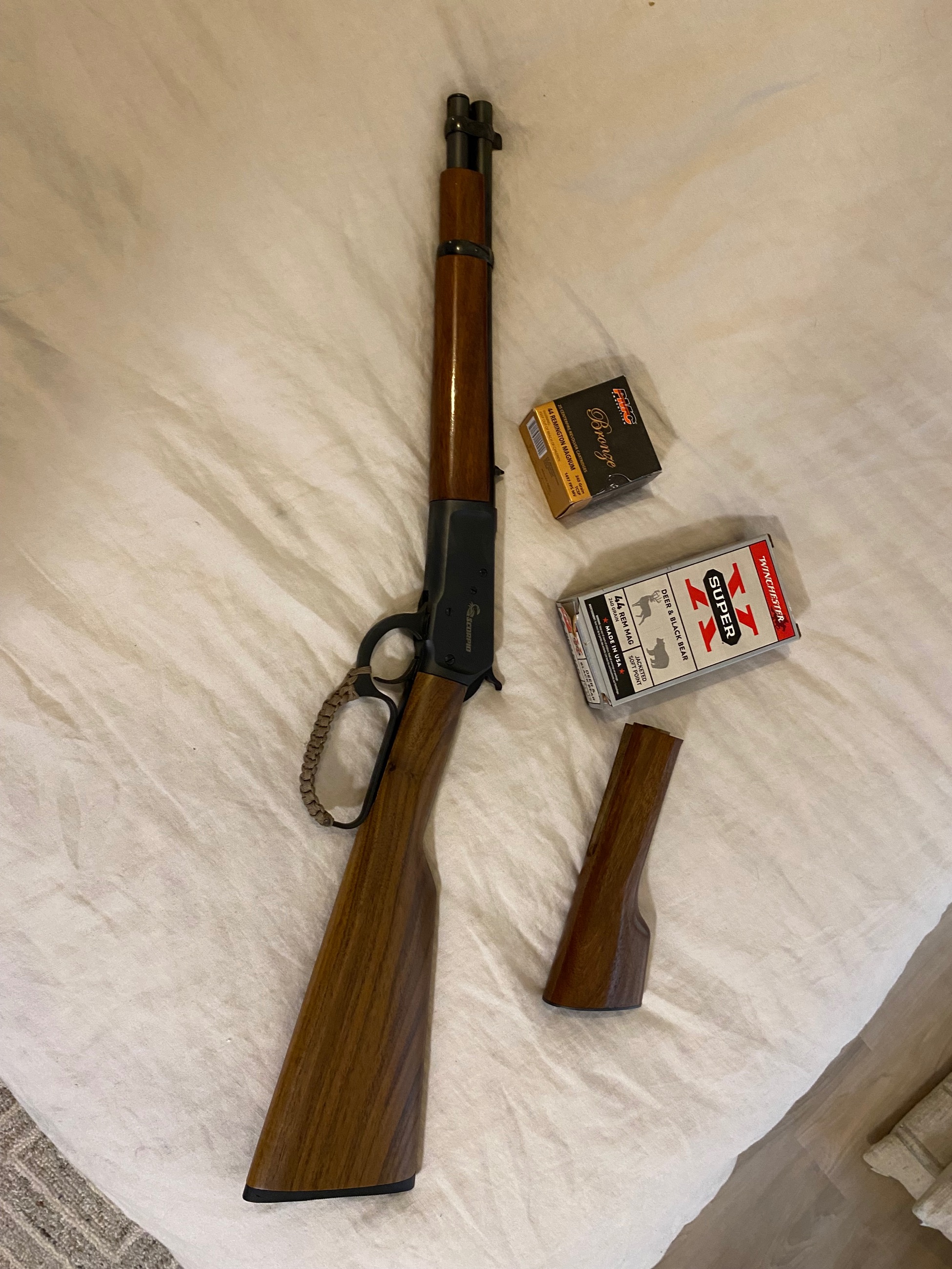 Photo of 44 mag Chiappa 1892 mares leg with both stocks and ammo