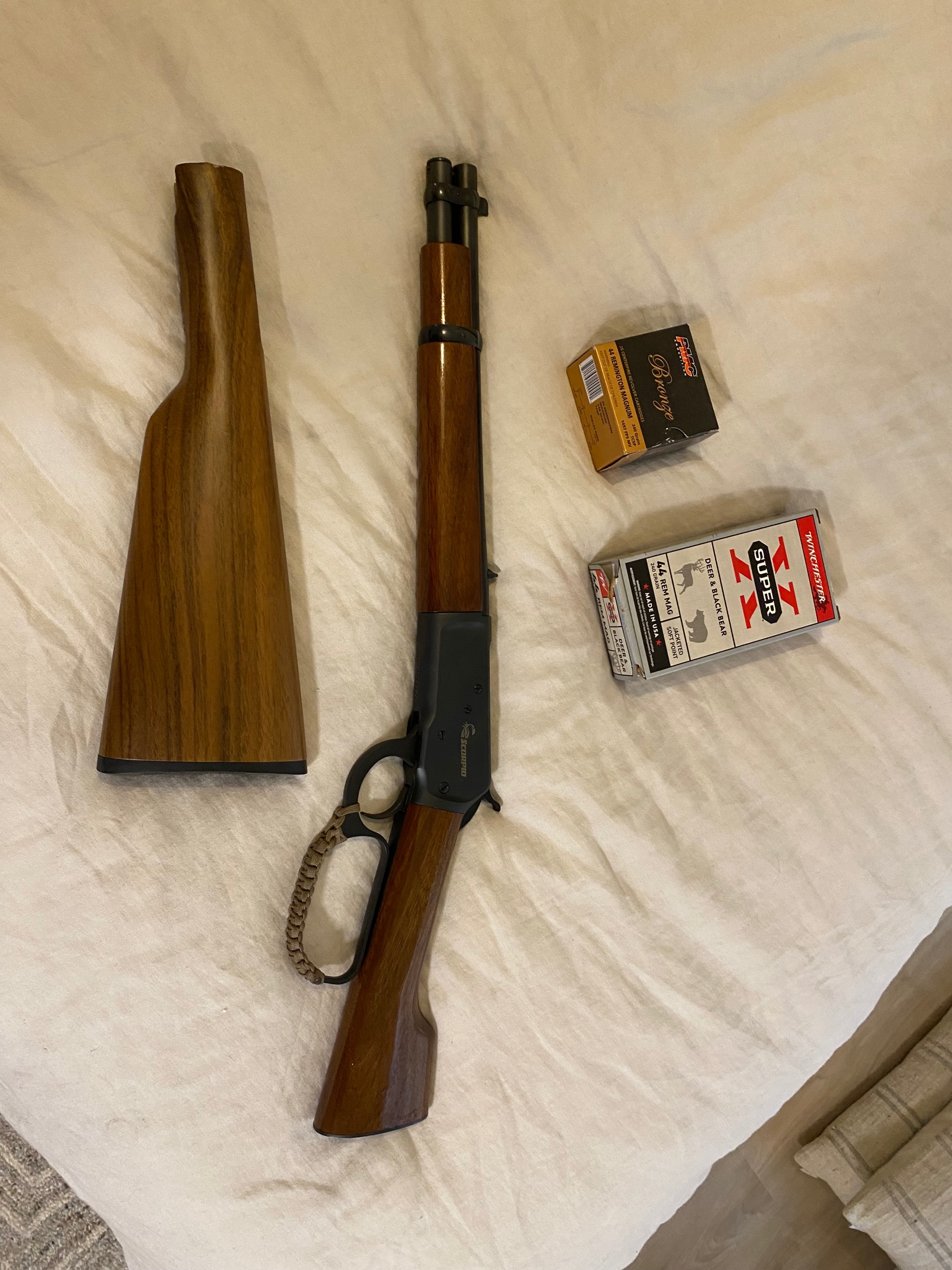 Photo of 44 mag Chiappa 1892 mares leg with both stocks and ammo